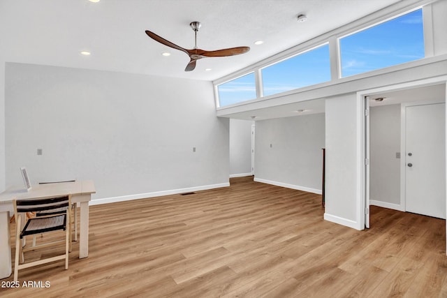 unfurnished living room featuring ceiling fan, baseboards, light wood-style floors, and recessed lighting