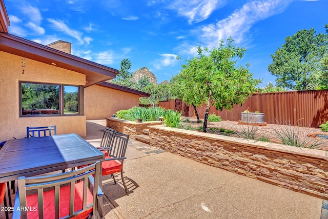 view of patio / terrace with outdoor dining space and fence