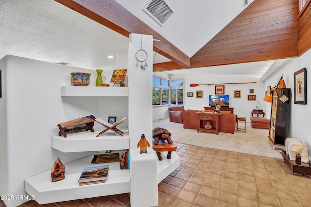 interior space featuring carpet floors, vaulted ceiling, a textured ceiling, tile patterned flooring, and recessed lighting