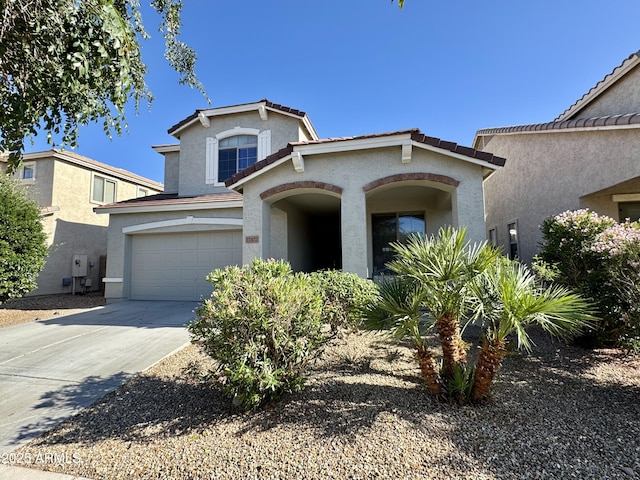 view of front of home with stucco siding, driveway, and a garage