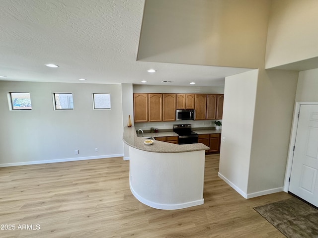 kitchen with stainless steel microwave, baseboards, electric range, recessed lighting, and light wood finished floors