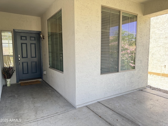 property entrance featuring stucco siding