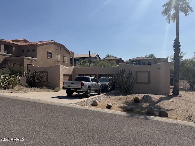 12029 N Fountain Hills Blvd Unit 1 & 2, Fountain Hills, AZ 85268 - view of front of home featuring concrete driveway, stucco siding, a residential view, and a garage