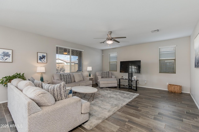 living room with dark hardwood / wood-style flooring and ceiling fan