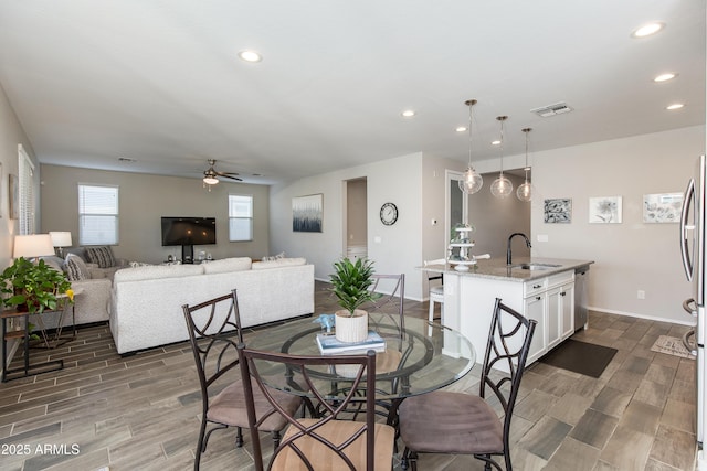 dining space featuring sink and ceiling fan