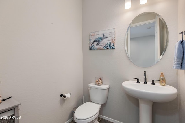 bathroom featuring toilet and sink