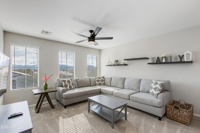 carpeted living room featuring ceiling fan