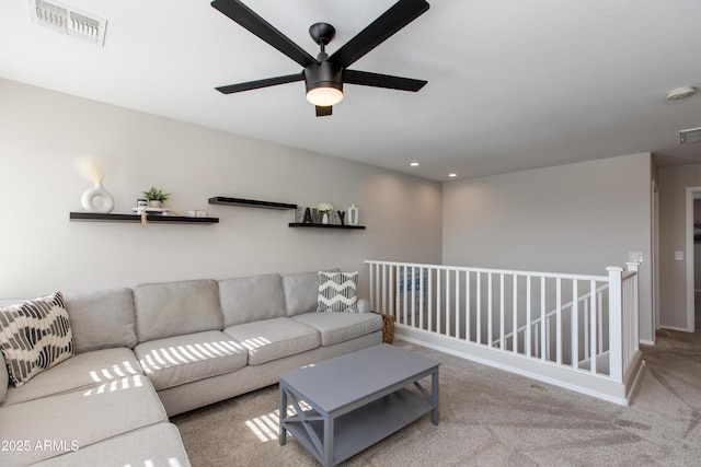 carpeted living room featuring ceiling fan