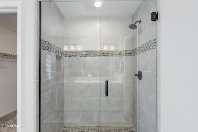 bathroom featuring a shower with door