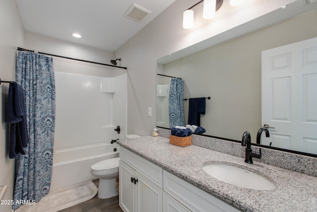 full bathroom with shower / tub combo with curtain, vanity, and toilet