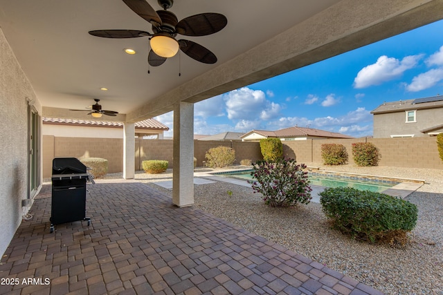 view of patio / terrace featuring a fenced in pool, grilling area, and ceiling fan