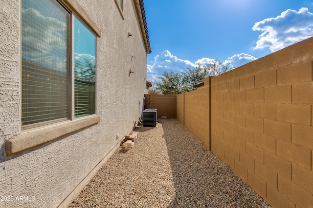 view of side of property featuring central air condition unit