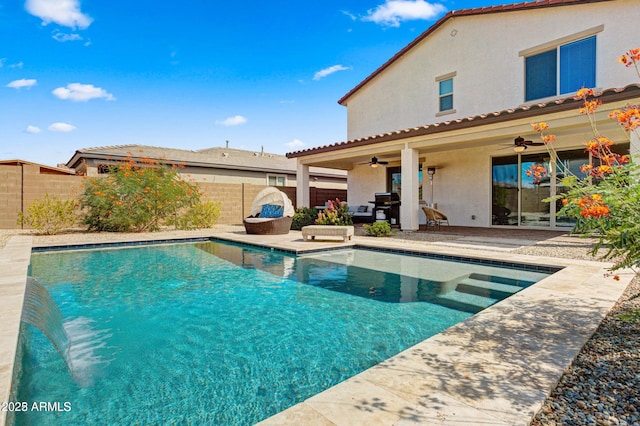 view of swimming pool with ceiling fan, grilling area, and a patio