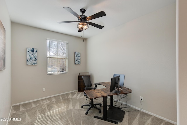 carpeted office featuring ceiling fan