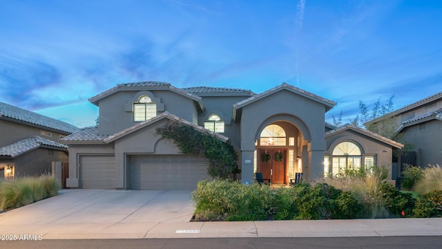 mediterranean / spanish house featuring a garage