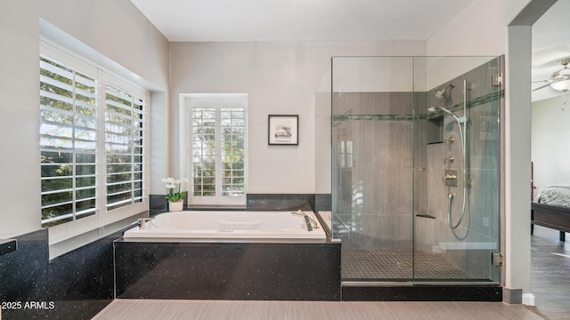 bathroom with ceiling fan and separate shower and tub