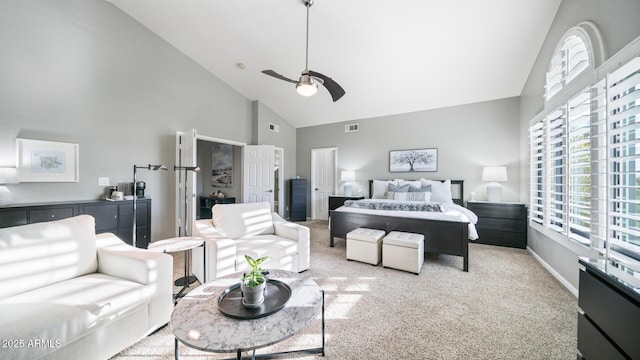 carpeted bedroom featuring ceiling fan and high vaulted ceiling