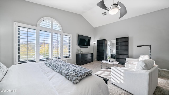 bedroom with multiple windows, lofted ceiling, ceiling fan, and carpet