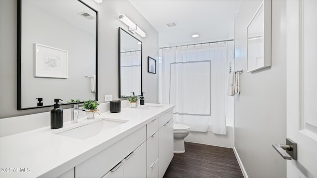 full bathroom with shower / bathtub combination with curtain, vanity, wood-type flooring, and toilet