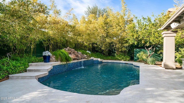 view of swimming pool with pool water feature