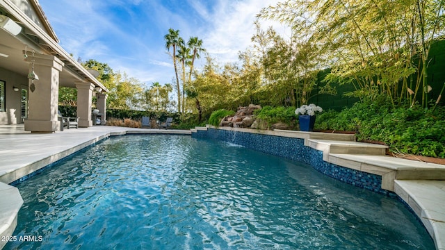 view of pool featuring pool water feature and a patio area