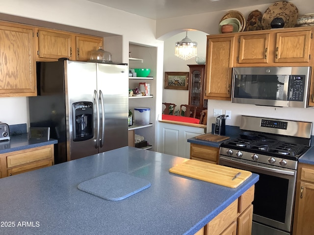 kitchen featuring stainless steel appliances and dark countertops