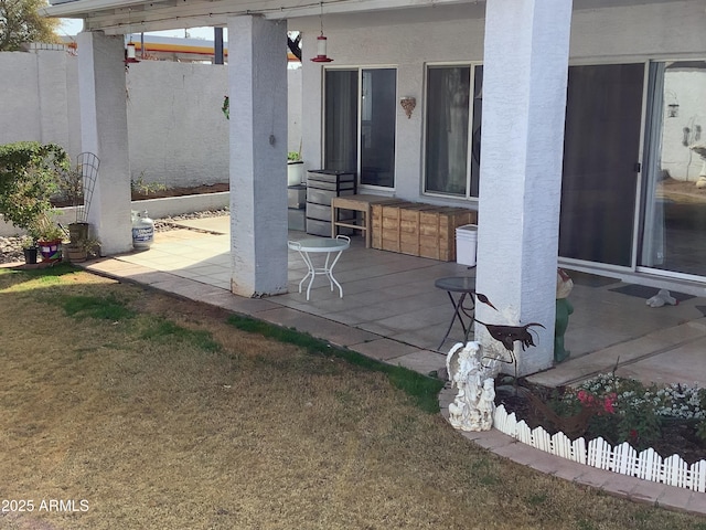 view of patio / terrace featuring fence