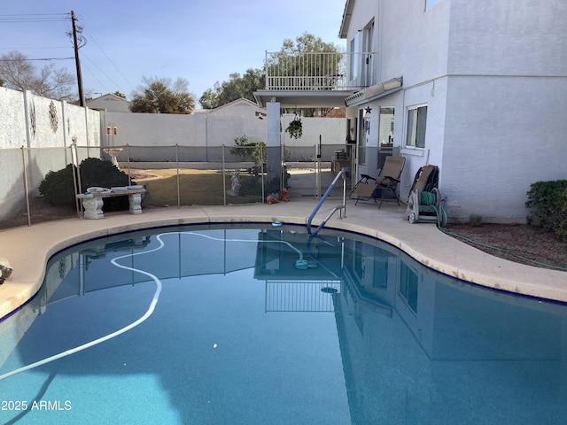 view of pool with a fenced backyard, a fenced in pool, and a patio