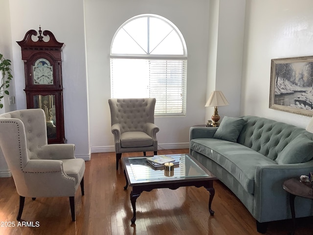 living area with wood finished floors and baseboards