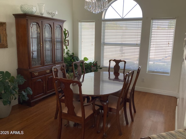 dining area featuring a healthy amount of sunlight, an inviting chandelier, and light wood-style floors