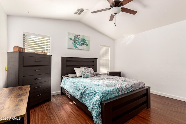 bedroom featuring vaulted ceiling, dark wood-style flooring, visible vents, and baseboards