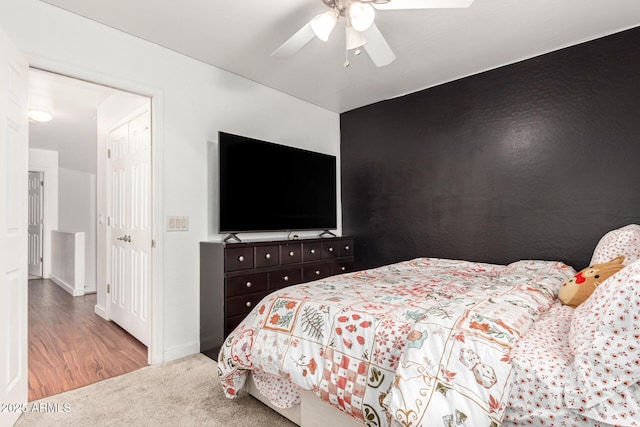 bedroom featuring light carpet, ceiling fan, and baseboards