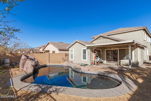 view of pool with a fenced in pool, a patio, a fenced backyard, ceiling fan, and french doors