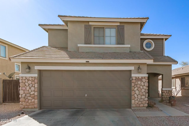 view of front of home featuring stone siding, driveway, and stucco siding