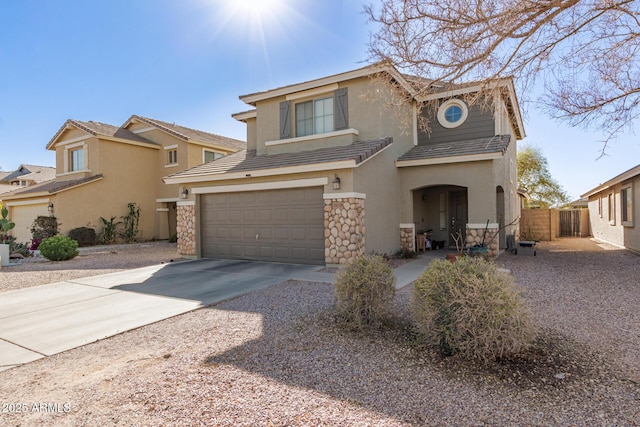 view of front of home featuring driveway, stone siding, a tiled roof, an attached garage, and stucco siding