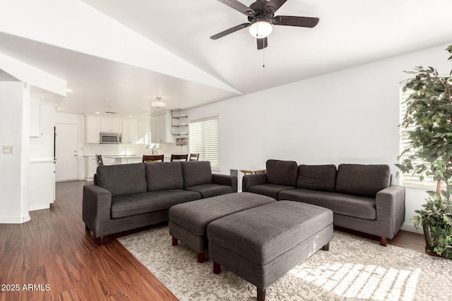 living area featuring lofted ceiling, ceiling fan, and wood finished floors