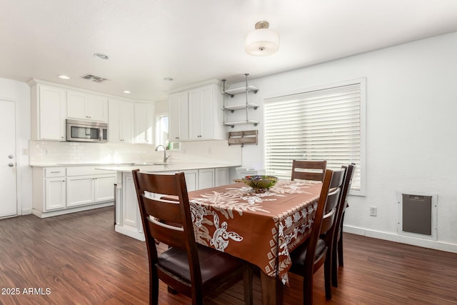 dining area with recessed lighting, dark wood finished floors, visible vents, and baseboards