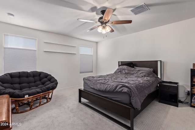 carpeted bedroom with multiple windows and ceiling fan