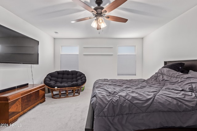 bedroom featuring multiple windows, carpet flooring, and ceiling fan