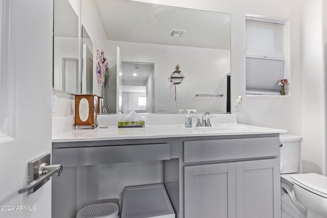 bathroom featuring vanity and toilet