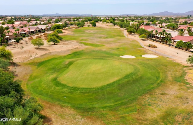 drone / aerial view with golf course view, a residential view, and a mountain view