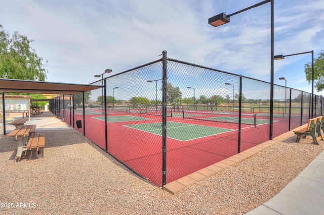 view of tennis court featuring fence