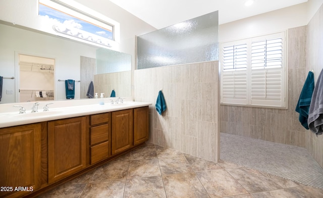 bathroom featuring tile walls, a wealth of natural light, and a sink