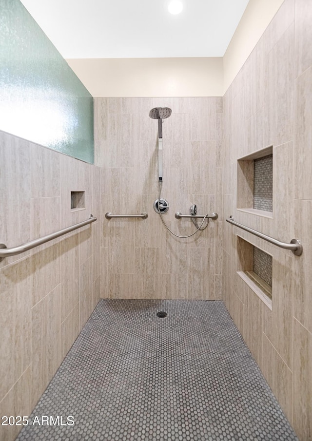 full bath featuring tiled shower