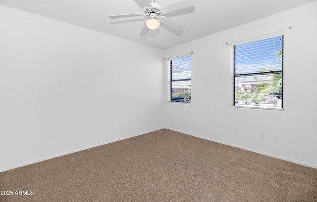 spare room with carpet flooring, baseboards, and a ceiling fan