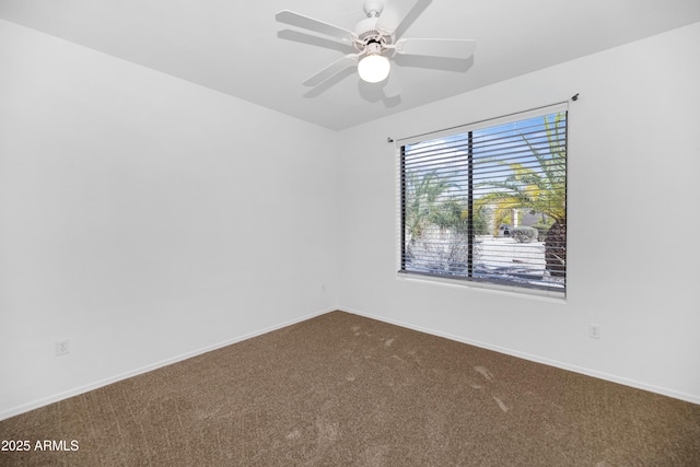 spare room featuring ceiling fan, baseboards, and dark colored carpet