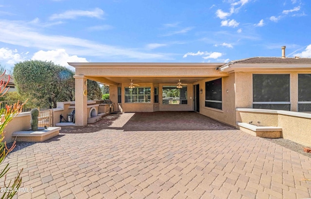 view of patio featuring area for grilling, a ceiling fan, and fence