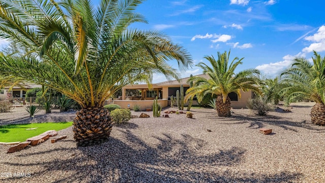 back of property featuring stucco siding and fence