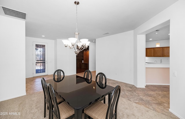 dining room with baseboards, visible vents, light carpet, and an inviting chandelier