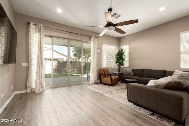 living room with ceiling fan and light hardwood / wood-style floors